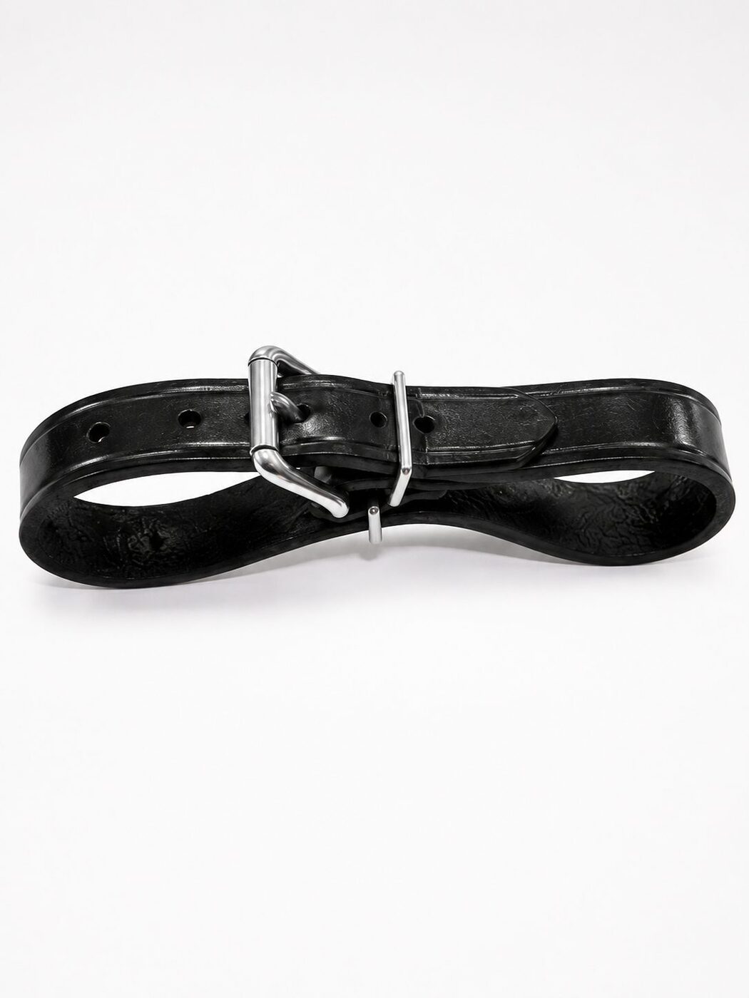 Black leather belt with a stainless roller buckle coiled on a light background